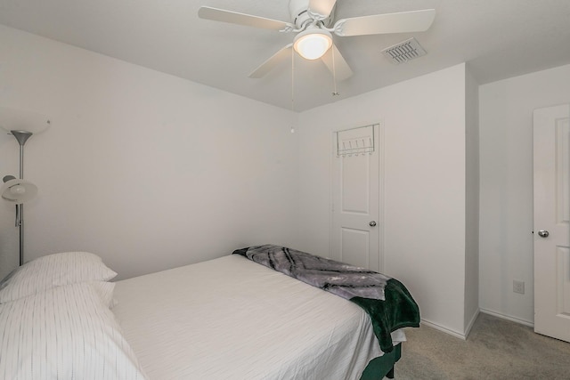 carpeted bedroom featuring visible vents, baseboards, and ceiling fan