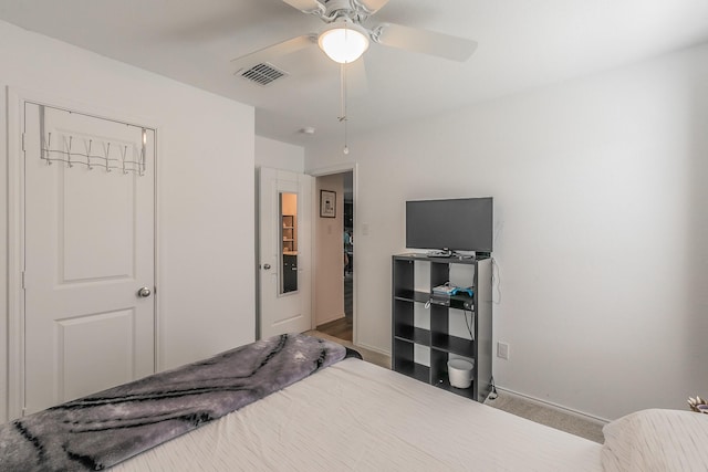 bedroom with visible vents, a ceiling fan, and baseboards