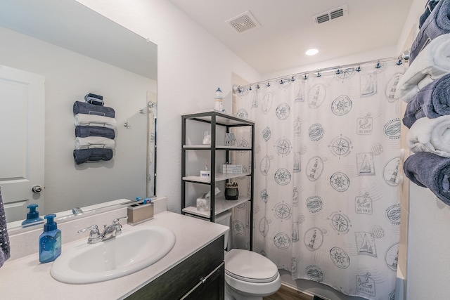 full bath with vanity, toilet, and visible vents