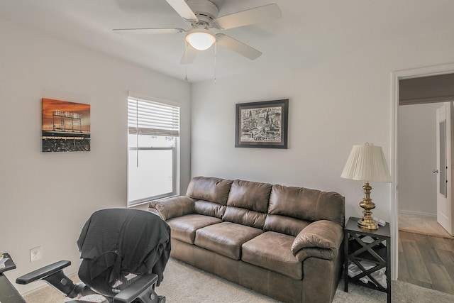 living area with ceiling fan and wood finished floors