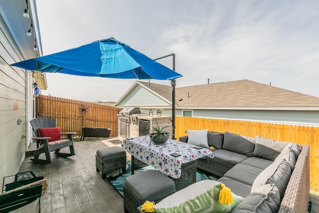 view of patio with outdoor lounge area, grilling area, a fenced backyard, and a wooden deck