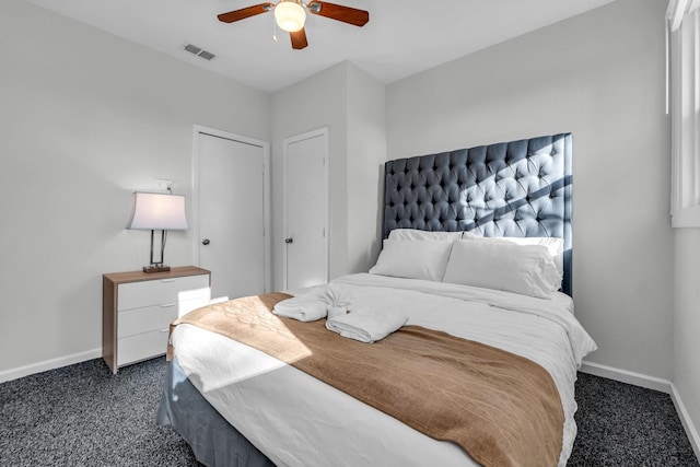 carpeted bedroom featuring visible vents, baseboards, and a ceiling fan