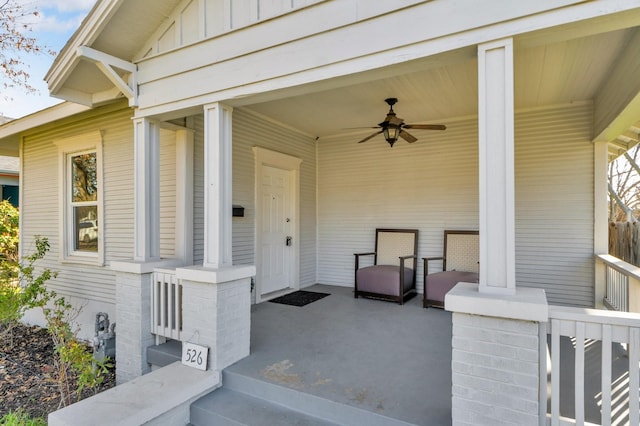 property entrance featuring covered porch, board and batten siding, and ceiling fan