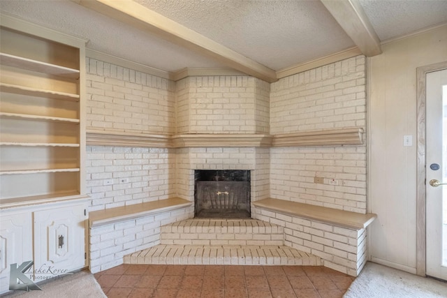 unfurnished living room featuring beamed ceiling, built in shelves, a textured ceiling, and a fireplace