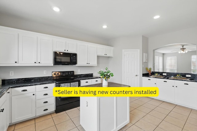 kitchen featuring light tile patterned floors, recessed lighting, white cabinets, and black appliances