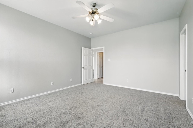 carpeted empty room with baseboards and ceiling fan