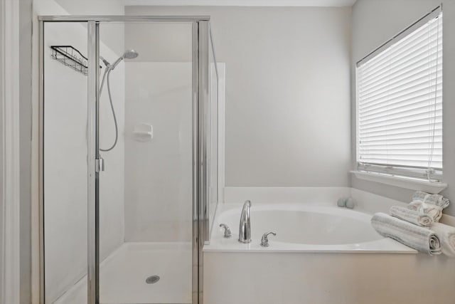 bathroom with a garden tub and a stall shower