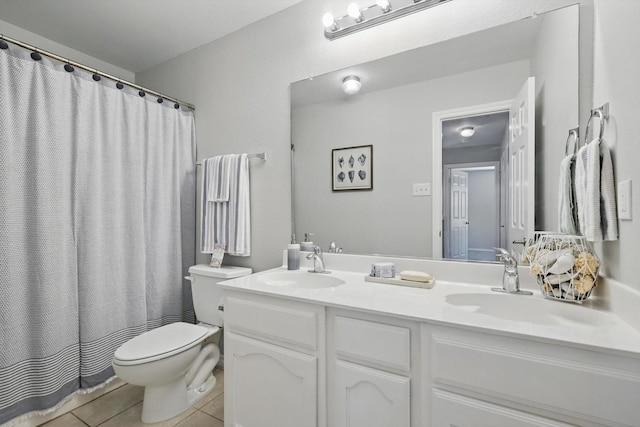 full bath with tile patterned flooring, double vanity, toilet, and a sink