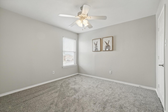 carpeted empty room with baseboards and ceiling fan