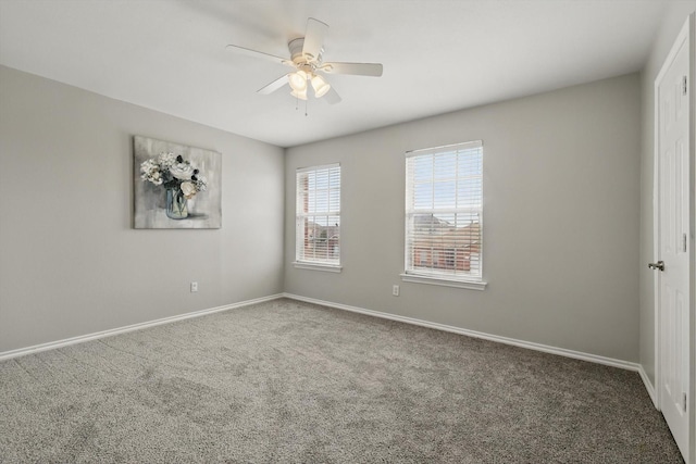 spare room featuring baseboards, a ceiling fan, and carpet flooring