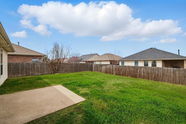 view of yard with a patio area and a fenced backyard