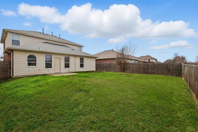 back of property featuring a patio area, a lawn, and a fenced backyard