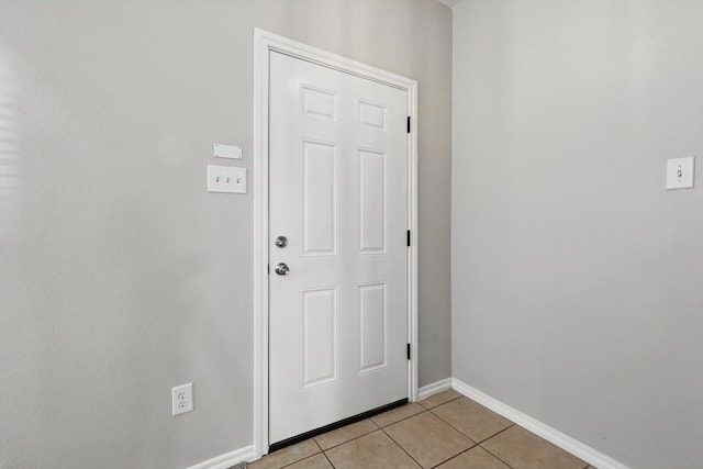 entryway featuring light tile patterned flooring and baseboards