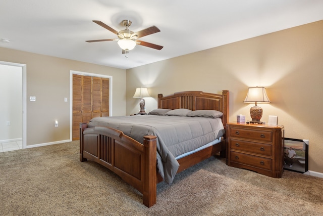 bedroom with a closet, carpet floors, baseboards, and ceiling fan