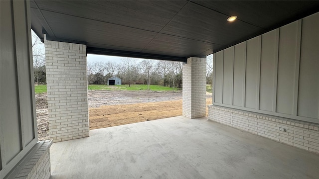 view of patio / terrace with a storage shed, an outbuilding, and a carport