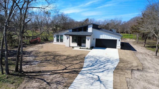 view of front of property featuring an attached garage, brick siding, driveway, and a shingled roof