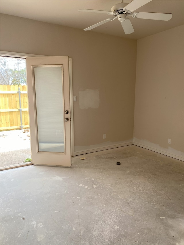 empty room featuring baseboards and a ceiling fan