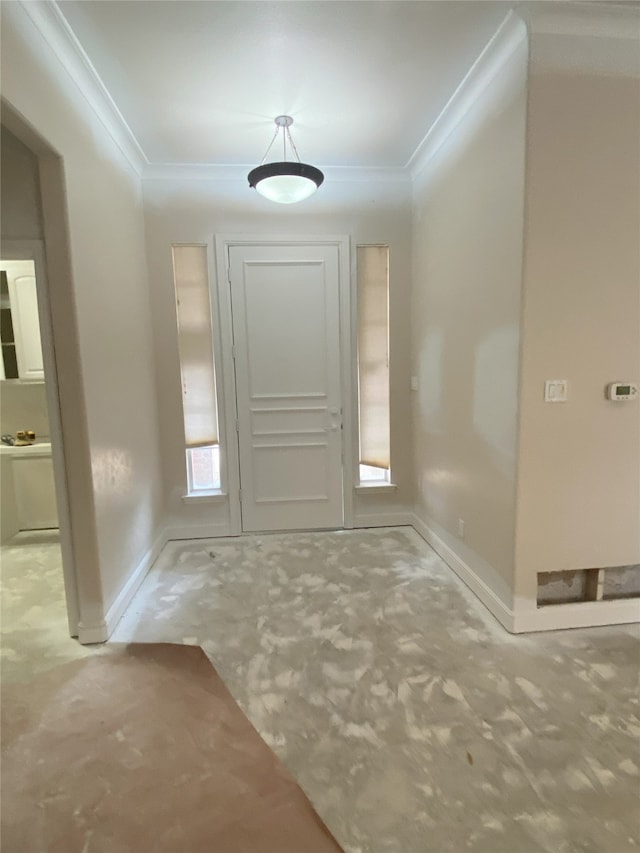 entrance foyer with baseboards and ornamental molding