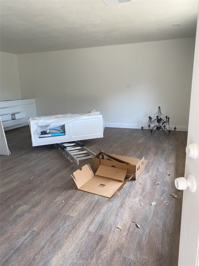 unfurnished room featuring visible vents, baseboards, and wood finished floors