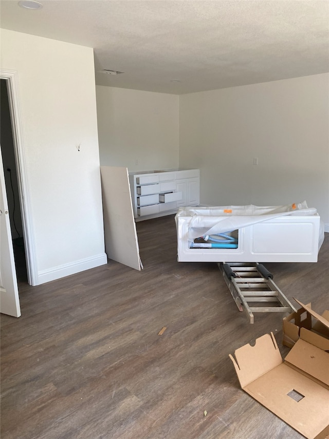 interior space with baseboards and wood finished floors