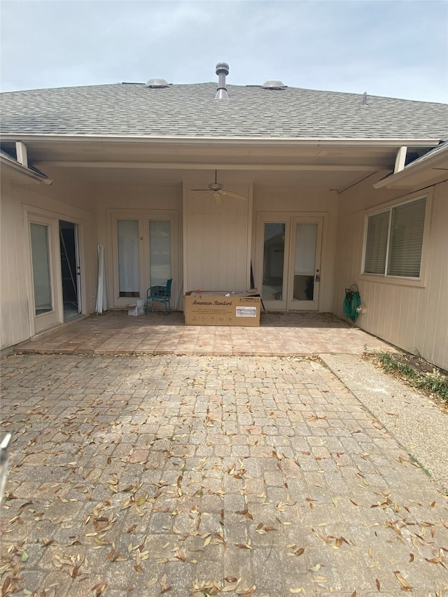 back of property featuring a patio area, a shingled roof, and ceiling fan