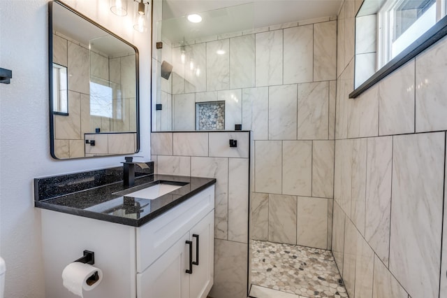 bathroom with walk in shower and vanity