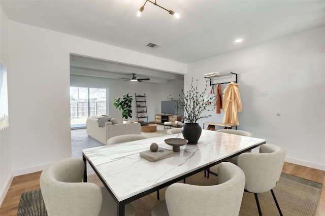 dining space with visible vents, ceiling fan, baseboards, and wood finished floors