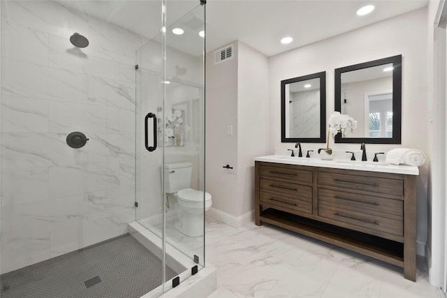 bathroom with marble finish floor, a stall shower, toilet, and a sink