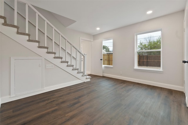 interior space featuring dark wood-style floors, recessed lighting, stairs, and baseboards