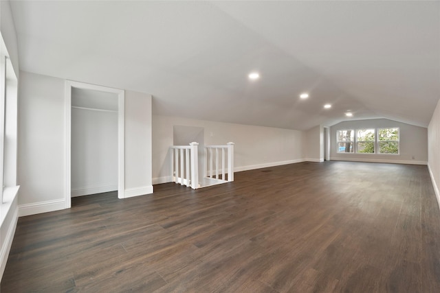 additional living space featuring lofted ceiling, recessed lighting, baseboards, and dark wood-style flooring