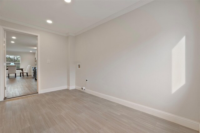 empty room with recessed lighting, baseboards, light wood-type flooring, and ornamental molding