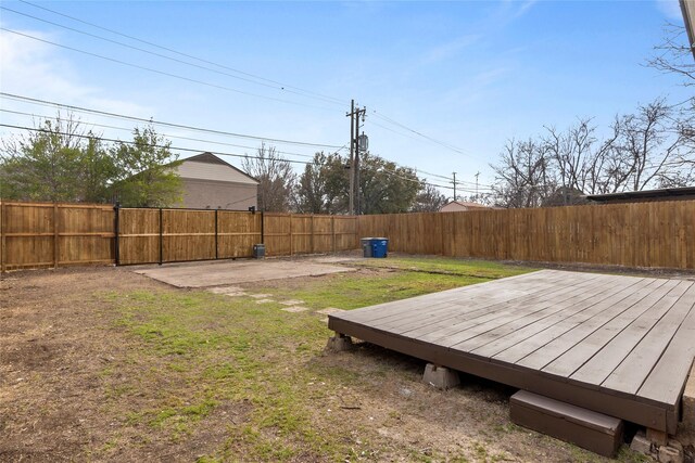 view of yard featuring a wooden deck and a fenced backyard