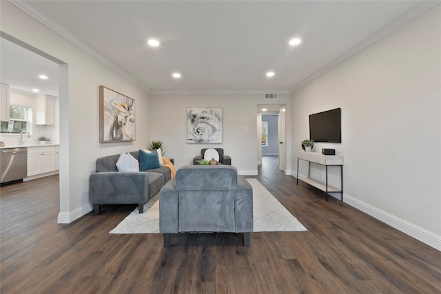 living room with dark wood finished floors, crown molding, baseboards, and visible vents