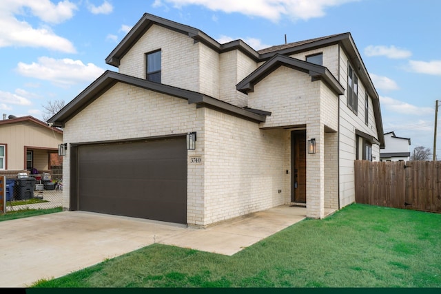 view of front of home featuring a front yard, concrete driveway, fence, and brick siding