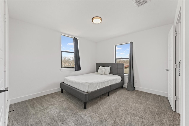 carpeted bedroom featuring visible vents and baseboards