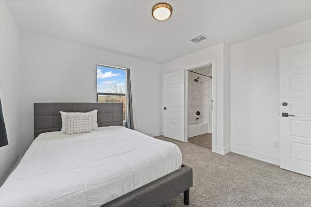 bedroom with visible vents, connected bathroom, baseboards, and carpet