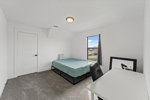 bedroom with vaulted ceiling, carpet, baseboards, and visible vents