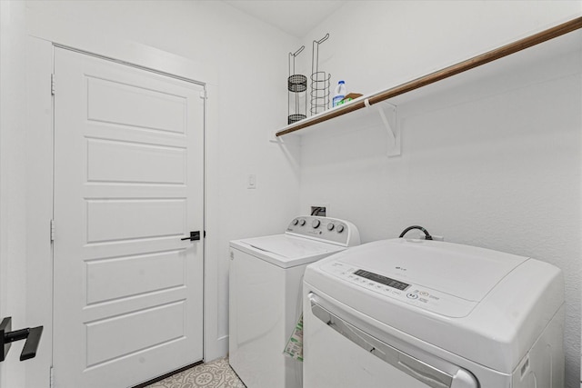 clothes washing area with washer and dryer and laundry area