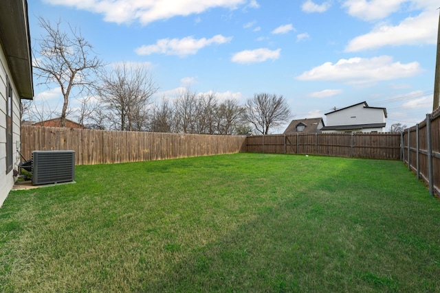 view of yard featuring central AC and a fenced backyard