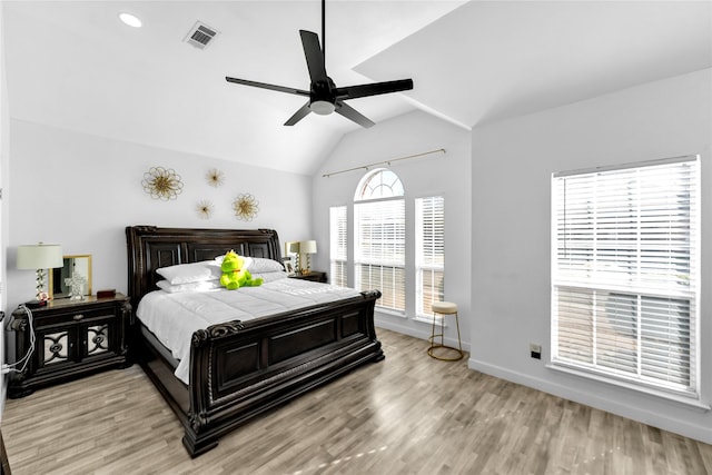 bedroom featuring visible vents, ceiling fan, baseboards, vaulted ceiling, and light wood-style floors