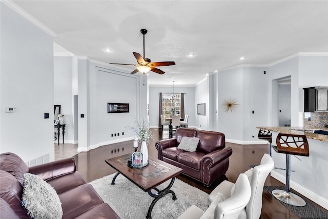 living room with recessed lighting, crown molding, baseboards, and wood finished floors