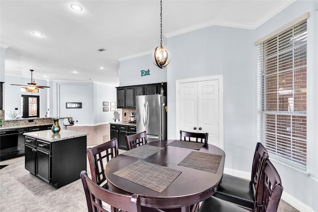 dining room featuring baseboards, lofted ceiling, recessed lighting, ceiling fan, and crown molding