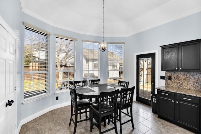 dining area featuring a wealth of natural light, baseboards, and ornamental molding