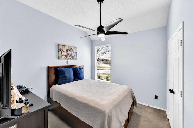 carpeted bedroom featuring baseboards, lofted ceiling, a textured ceiling, and a ceiling fan