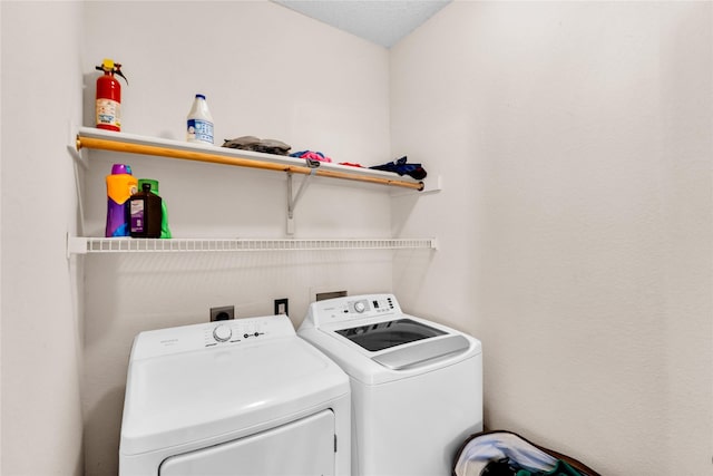 washroom with laundry area and washer and dryer