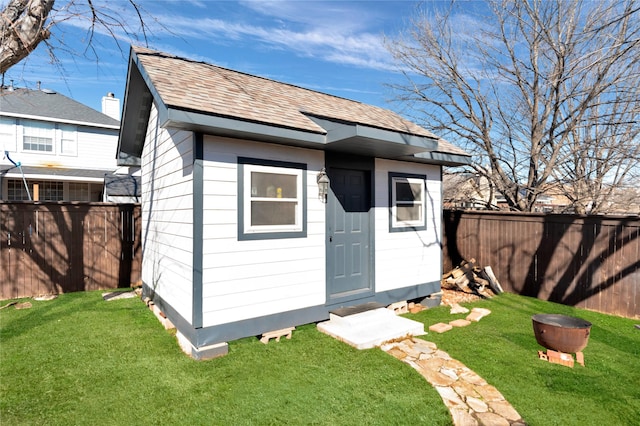 view of outbuilding featuring an outdoor structure and a fenced backyard