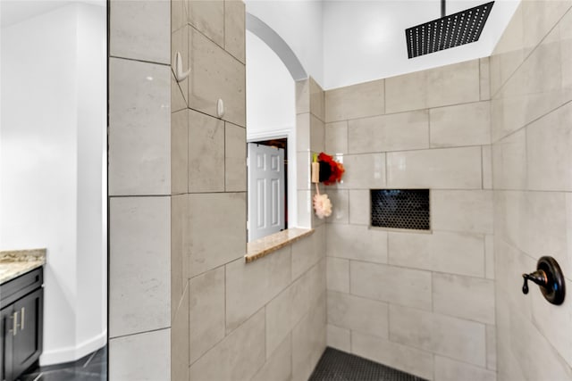 full bathroom with vanity and a tile shower