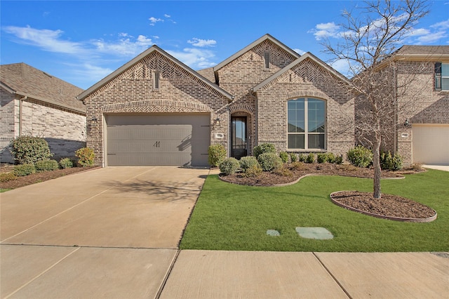 french country home featuring a front lawn, brick siding, concrete driveway, and an attached garage