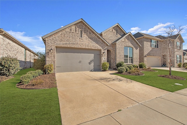 view of front of property with driveway, brick siding, an attached garage, and a front lawn