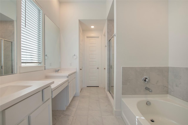 bathroom featuring a sink, a garden tub, two vanities, and a stall shower